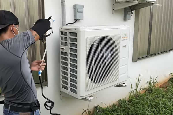 man wiring outdoor AC condenser