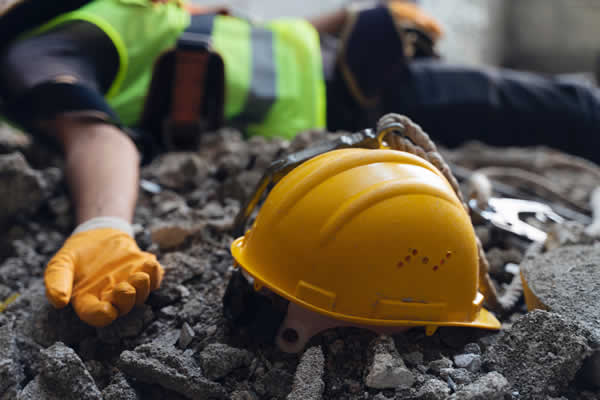 injured construction worker lying on ground
