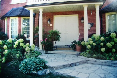 Front of home with exceptional landscaping
