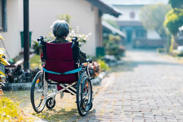 woman outside sitting in a wheelchair