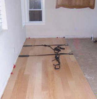 Engineered hardwood flooring glued to concrete floor.