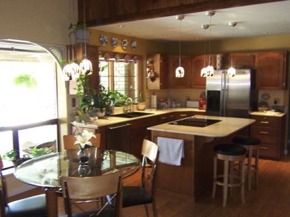 Pendent lighting used as task lighting to illuminate the kitchen table and island countertop