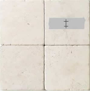 ceramic tile with duct tape marked for drilling