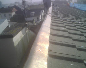 Copper ridge plate installed on roof to control moss growth