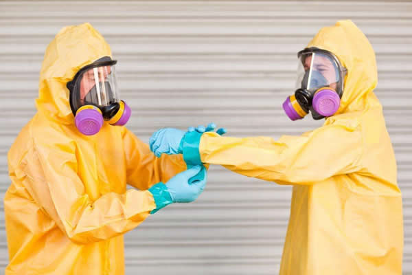 2 men putting on protective clothing