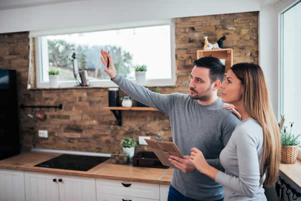 man and woman in kitchen having a discussion