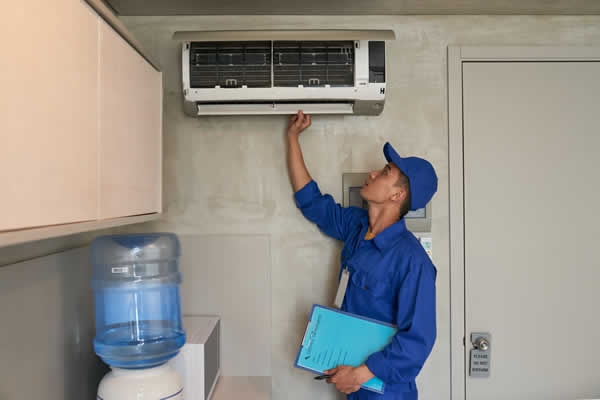 man checking an air conditioner