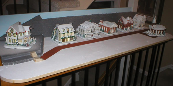Christmas village buildings positioned from left