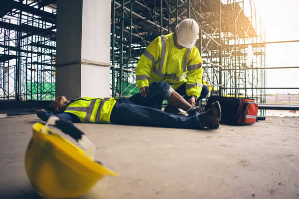 construction worker on ground with leg injury