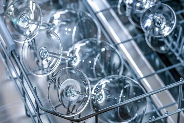 dishwasher tray filled with wine glasses