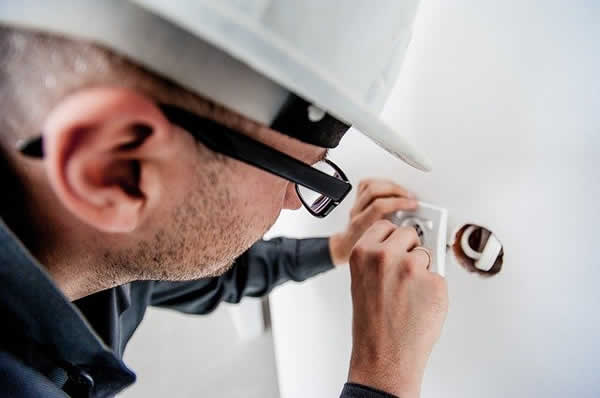 electrician wiring a receptacle