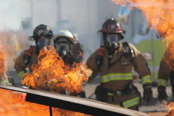 firemen behind a fire