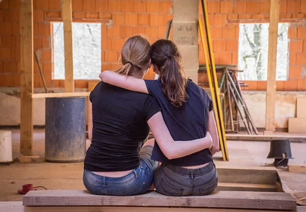 two girls looking at unfinished reno