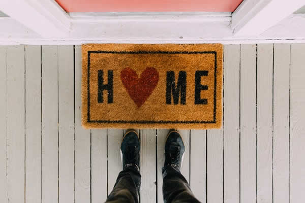 sisal door mat that says home and the letter O is a heart