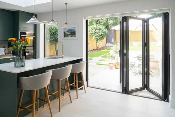 exterior, full length, glass folding doors from kitchen to backyard