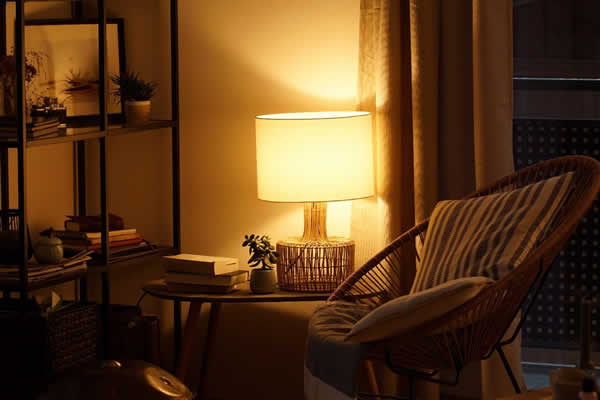 lit lamp in room with chair