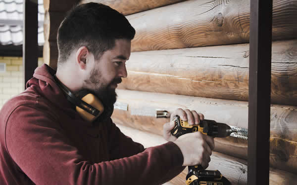 man using an electric drill