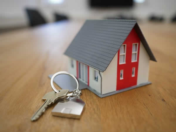miniature house on table with key