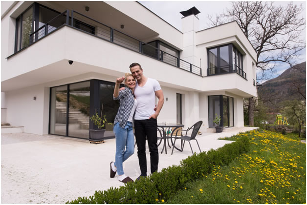 2 people standing in front of new home