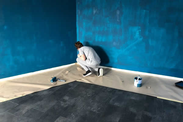 person painting walls