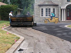 Asphalt being laid and compacted