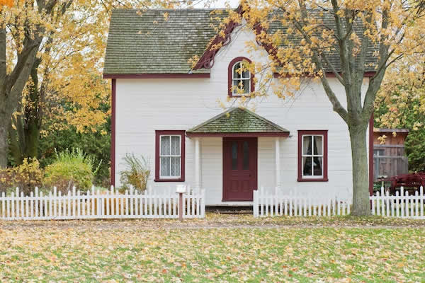 small whit house with red trim