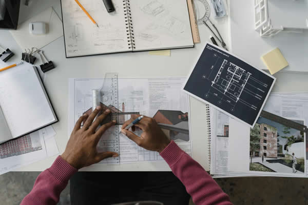 man working of building plans