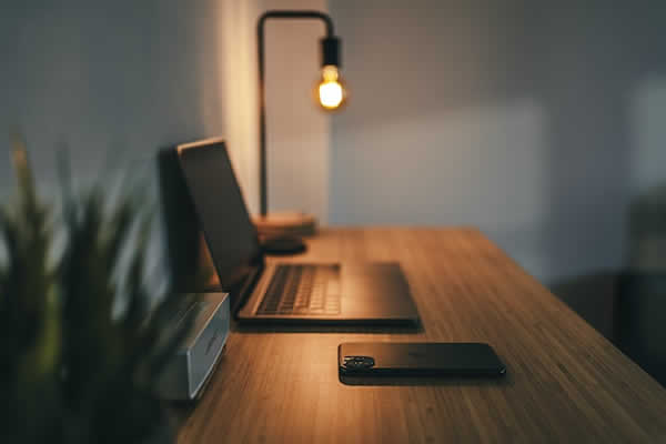 laptop on desk with desk lamp on