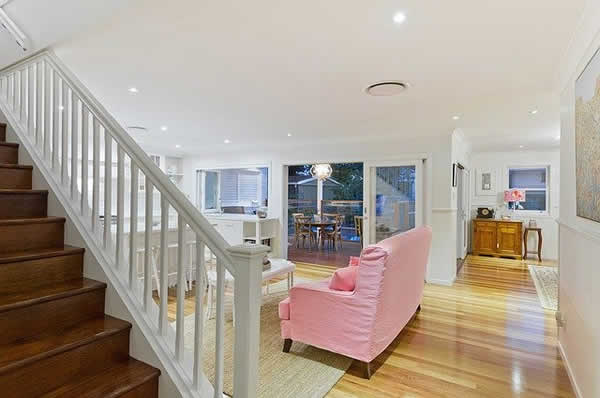 room with stairs and pink sofa