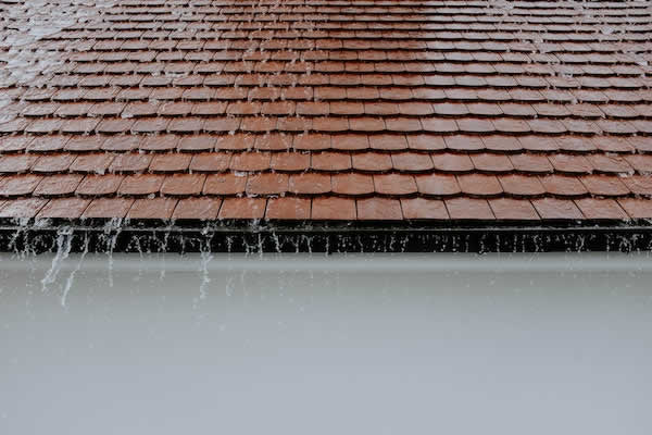 brown roof during a rain storm