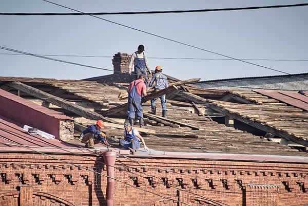 repairing roof on old industrial building