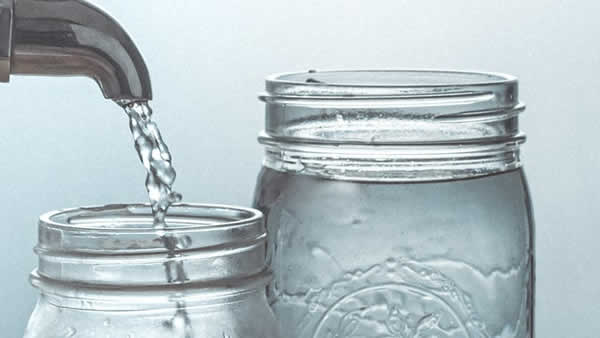 water spout filling mason jars
