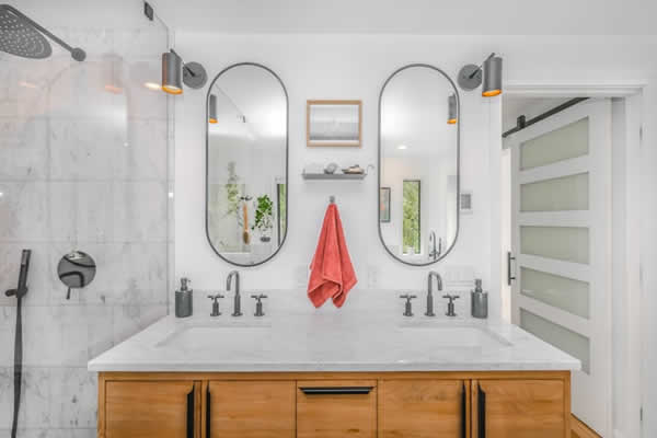 2 bathroom wall mirrors over a vanity