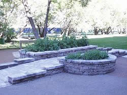 The centers of these raised garden beds would be difficult to access for someone in a wheelchair because of the depth of the top layer of bricks around the beds.