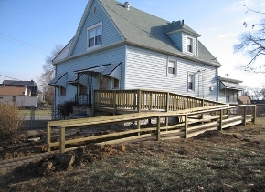 Horizontal boards between support posts provide a railing on this wheelchair ramp.