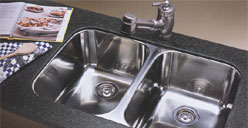 Kitchen faucet mounted behind kitchen sink