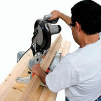 Crown molding being cut using the crown molding miter saw cutting jig