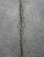 Longitudinal crack in asphalt driveway
