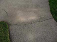 Crack in asphalt walkway